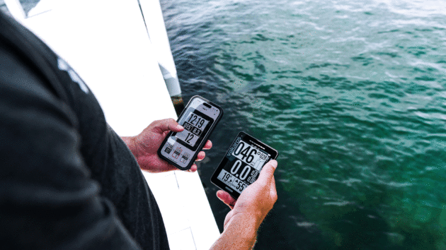 Someone holding devices on a yacht