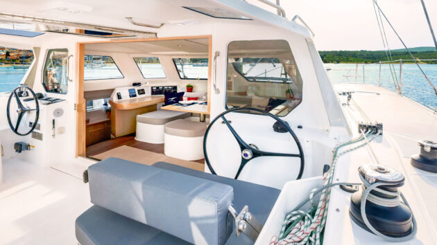 Hinged helm seat backrest allows seating facing forward or aft